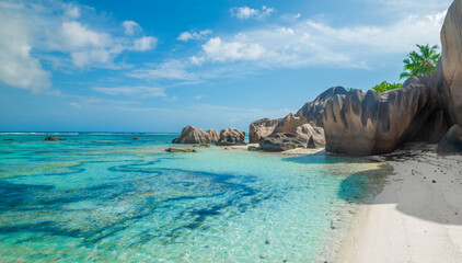 White sand, turquoise water and granite boulders in a tropical beach