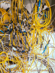 The maze of cables and plugs: close up of a cluttered internet connection box
