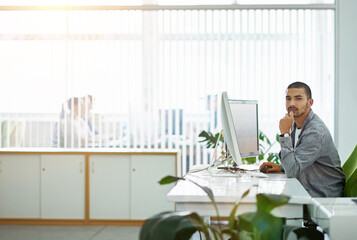 Fototapeta premium Business, portrait and man with a computer in office for online planning, proposal or connection. Lens flare, employee or graphic designer at desk with confidence, job growth or project development