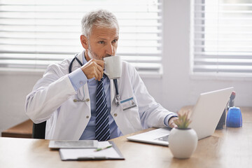 Hospital, laptop and doctor with coffee in office for medical service, research and online...