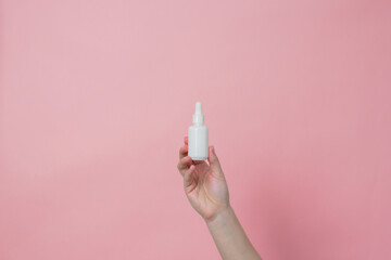 Glass unbranded white bottle with serum or essential oil with pipette. Natural moisturizing,...