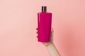Cosmetic unbranded bottle for shampoo, mask, lotion in hand. Concept of beauty. Product cosmetic...