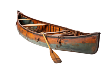 A wooden canoe with a paddle on it. The canoe is old and has a blue and green color