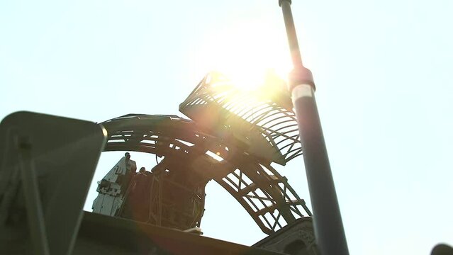 Air defense. Radar is installed on air defense systems and folded into the stowed position. Army radar antenna against a background of clear sky and sun. Mobile Military Air Defense Radar.