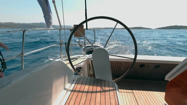 A yacht and a skiff behind it at sea while sailing
