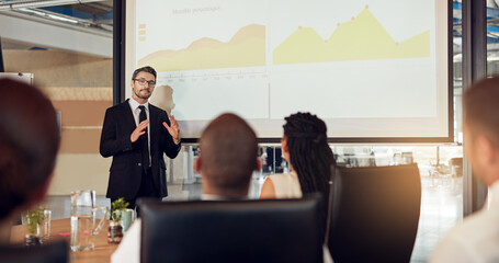 Businessman, presentation and meeting audience with graphs in boardroom for financial analysis, charts or report. Colleagues, office and review for company accounting or budget, investment or growth