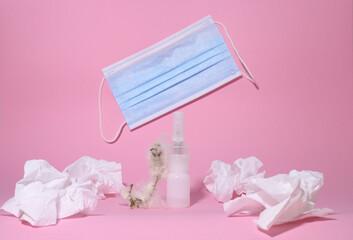 allergy. disease. on a pink background, a white bottle with medicine and a twig with fluff, napkins...