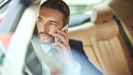 Businessman, travel and speaking with phone call in car for commute, conversation or communication. Man or employee on mobile smartphone for business discussion in vehicle, taxi or cab on work trip