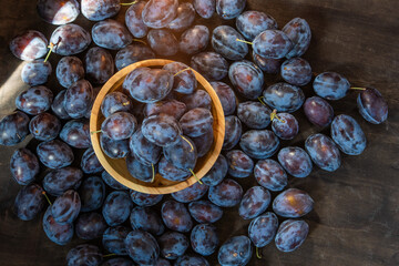 Plum variety Hungarian. Fruit harvest on the table in the kitchen. Autumn blue plum. Vitamin food bowl.