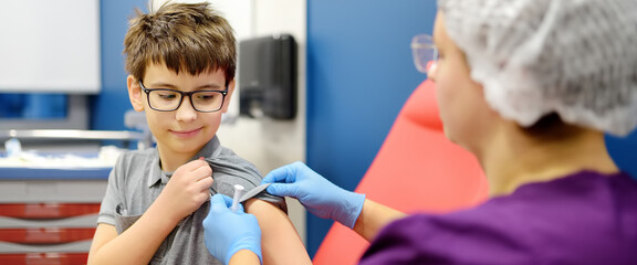 A boy is being vaccinated. A child is given a vaccine during an epidemic or outbreak of a disease.
