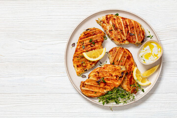 juicy grilled chicken cutlets on plate, top view