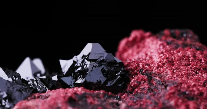 Black Hausmannite on red andradite footage, rotating clip. From NChwaning II Mine, Kuruman, Kalahari, Northern Cape Province, South Africa
