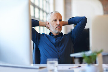 Fototapeta premium Mature, businessman and relax in office with laptop in chair for reading, comfortable and research by workspace. Professional, CEO and stretching for corporate project, productivity and planning