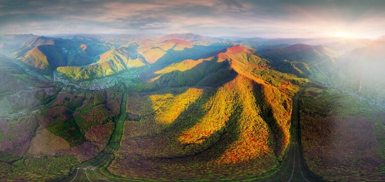 drone flies over a spring Carpathian peak with an interesting phenomenon - the mountain forest on the mountain is green up to a certain height, and above without leaves