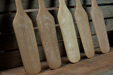 Cooking spatulas made from wood are arranged neatly in the kitchen. Ready to cook next time
