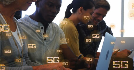 Image of multiple 5g texts over diverse coworkers working and using laptop in office