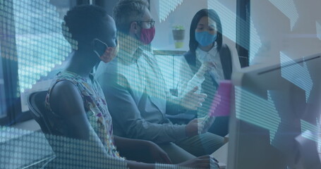 Image of multiple arrows over diverse coworkers wearing masks and discussing reports in office