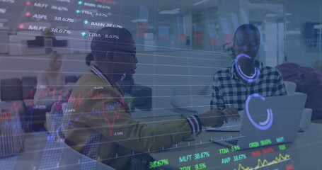 Image of stock market data processing against diverse man and woman discussing at office