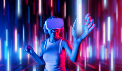 Smart female standing in cyberpunk style building in meta wear VR headset connecting metaverse, future cyberspace community technology, Woman using hand touching virtual reality object. Hallucination.