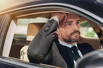 Businessman, professional and thinking or driving in car for commute to corporate work or job as...