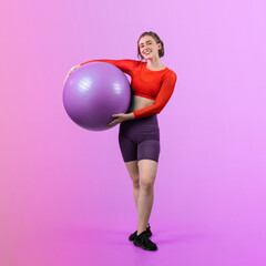 Full body length gaiety shot athletic and sporty young woman with fitness exercising ball in...