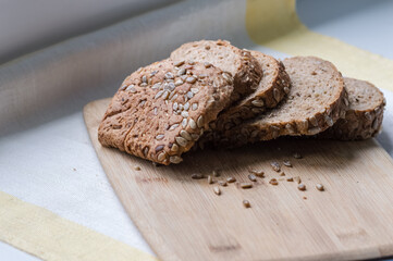 Sliced wholemeal bread with sunflower seeds on wooden board