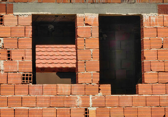 Emerging Dimensions. Construction in Light and Shadow. Brick wall, background. Windows frames....