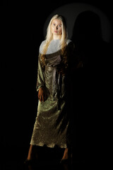 Low key portrait of blonde woman in dress