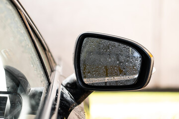 man washes his car at the car wash