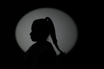 Silhouette of a woman in shadows