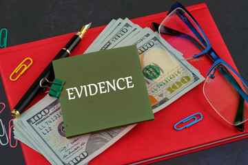 Word EVIDENCE composed on a sticker on the background of a business notebook and dollars