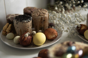 easter cake with chocolate and eggs on a white plate