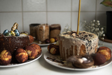 easter cake with chocolate and eggs on a white plate