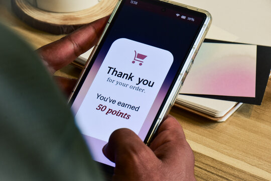 Customer loyalty program concept for digital marketing strategy. Man earned points shopping online using the mobile application.