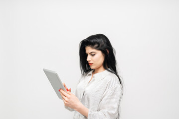 Portrait of young businesswoman using tablet on white background.