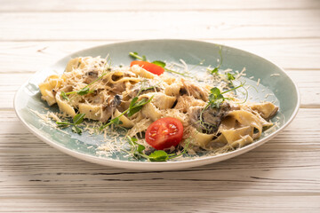 fettuccine carbonara or truffle pasta, spaghetti, mushroom noodle in creamy sauce serving with tomatoes in restaurant