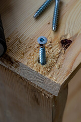 a partially twisted confirmation into a freshly drilled hole in the board