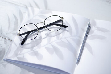 メガネとノートの明るい背景素材