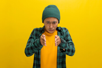 A displeased Asian man, dressed casually in a beanie hat and casual clothes, is gesturing a small...