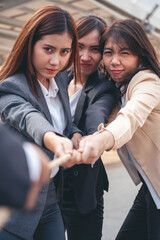 Tug of war Businesswoman Team holding hands together partnership leader teamwork. Group of business people Hands pulling rope symbol team unified teamwork Partnership Concept. diversity competition