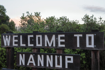 Fototapeta premium Welcome to Nannup wooden sign post. Tourism and event hotspot, South West, Western Australia. Host 2026 UCI Gravel World Championships.