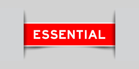 Red color square label sticker with word essential that inserted in gray background