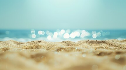 Fototapeta premium An abstract seascape beach background with a soft blur of bokeh light illuminating the calm sea and sky while the focus lies on the sandy foreground : Generative AI