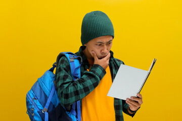 A pensive young Asian student, dressed in a beanie hat and casual shirt, carrying a backpack and...