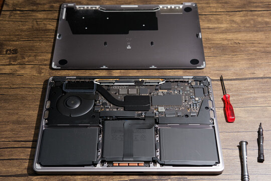 Newcastle UK: 22nd April 2024: A MacBook Pro M1 13 inch broken and ready for repair. interrior parts faulty logicboard inspection