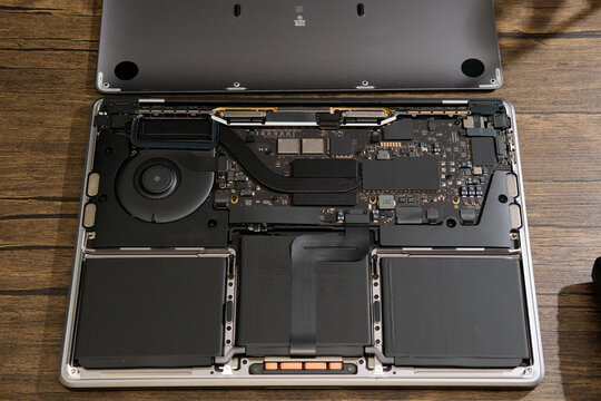 Newcastle UK: 22nd April 2024: A MacBook Pro M1 13 inch broken and ready for repair. interior parts faulty logicboard inspection