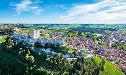 Aerial view of the famous castle of Peñafiel in Valladolid at dusk, with the old village and wine...