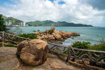 Nha Trang Vietnamese resort coastline is revealed in vibrant spectacle. picturesque rocky coast meet azure sea under radiant sun, panorama of beaches and crystal-clear waters