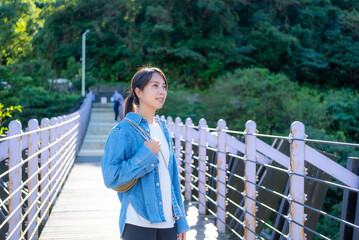 Woman walk over the suspension bridge at outdoor