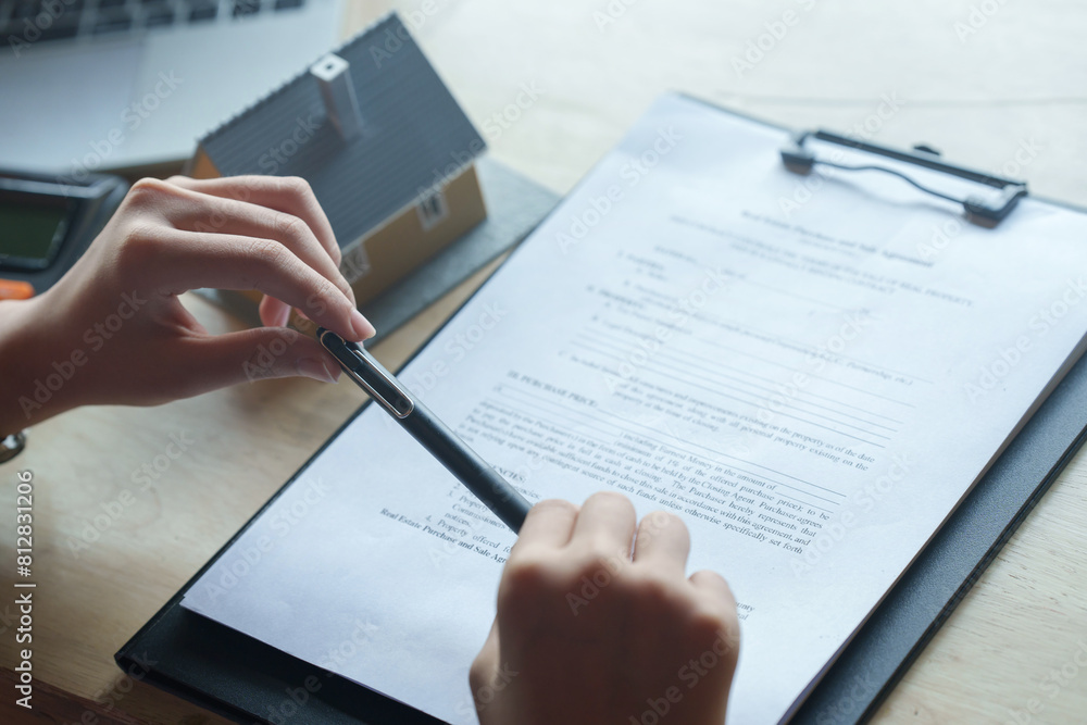 Wall mural Interest and loan concept, woman is calculating house interest with documents.